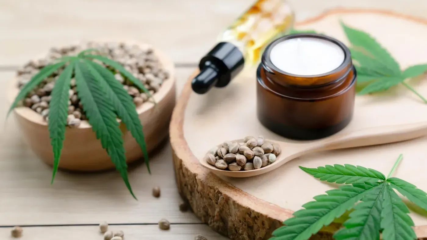 CBD dropper and cream jar with seeds